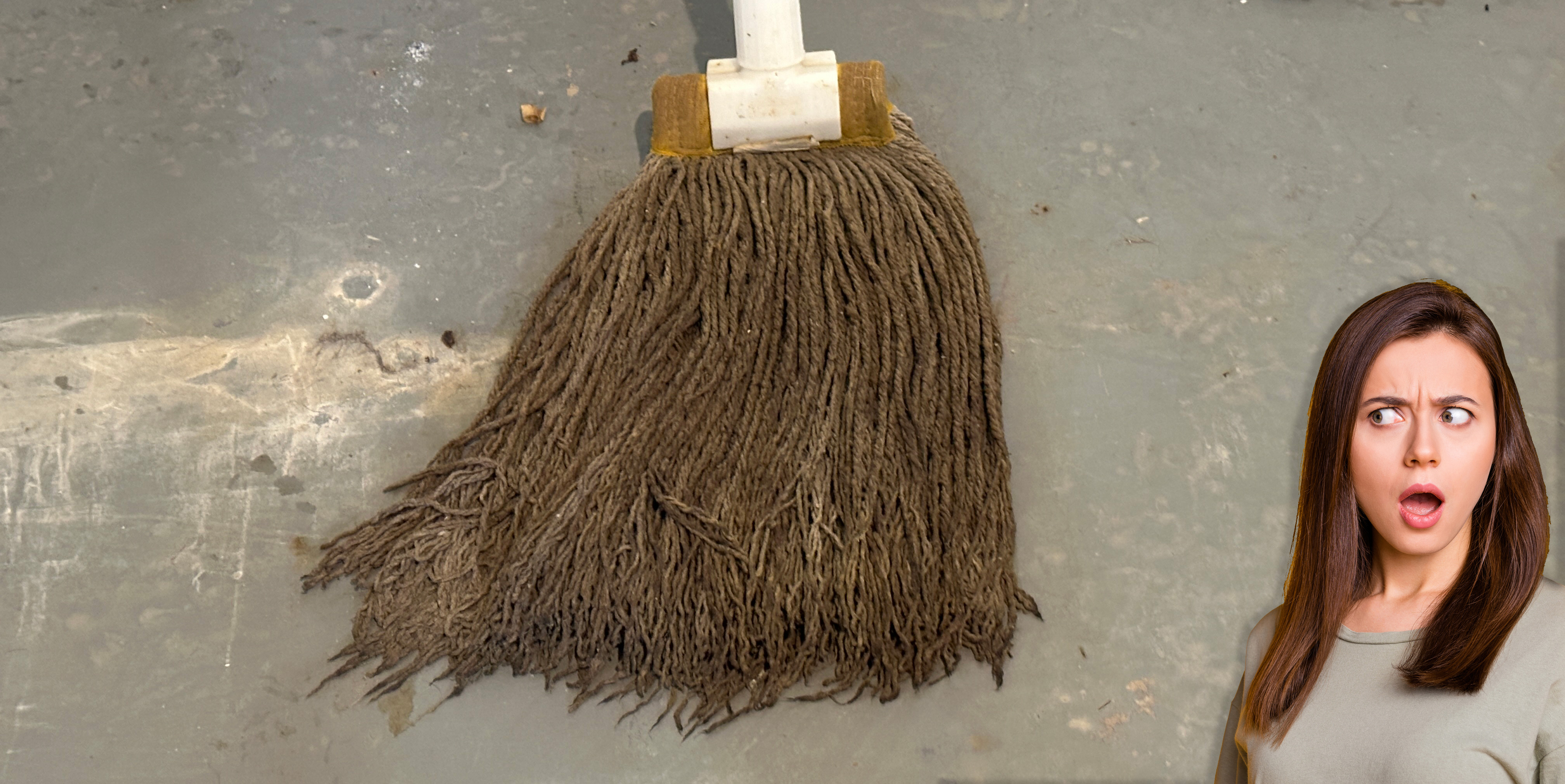 Woman's shocked face as she looks at a dirty, disgusting string mop.